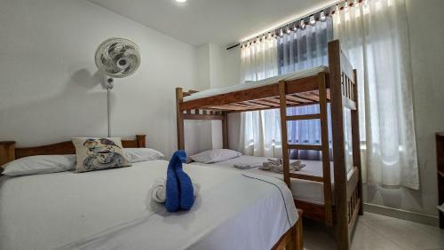 a bedroom with two bunk beds and a blue towel at Hotel Sueños Libres Necoclí in Necoclí