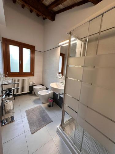 a bathroom with a shower and a toilet and a sink at Appartamenti Portavenezia in Padova
