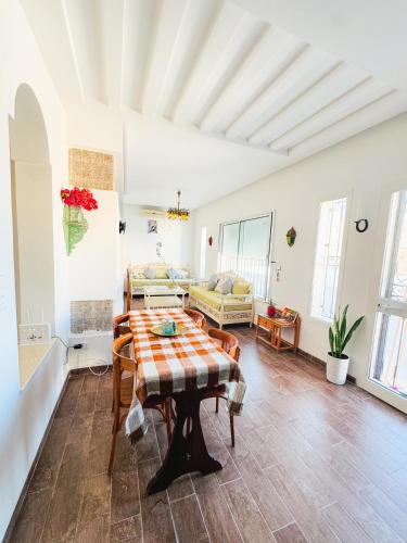a living room with a table and a couch at La Maison de haut in Tunis