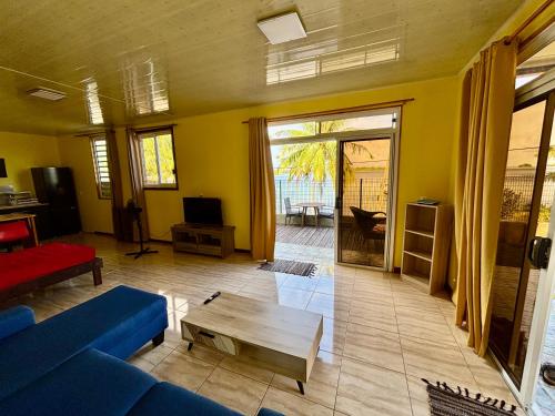 a living room with a blue couch and a table at O'Hani-Ura lodge in Bora Bora