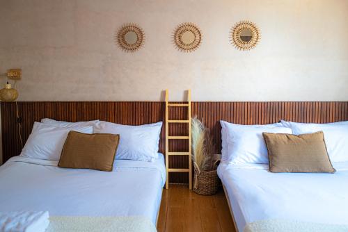 two beds sitting next to each other in a room at Destiny Hotel - 1605 in Sampong