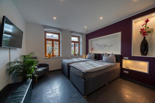 Ένα ή περισσότερα κρεβάτια σε δωμάτιο στο Villa-Harmonie Dresden