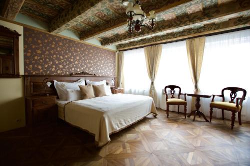 Postel nebo postele na pokoji v ubytování Hotel Residence U Černého Orla