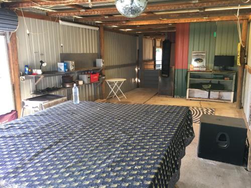 a room with a bed in the middle of it at 3 Campsites ONLY for Self contained Motor Homes RVs ONLY! BYO Toilet and bed! DIDO Spirit of Tasmania Stopover in Lara