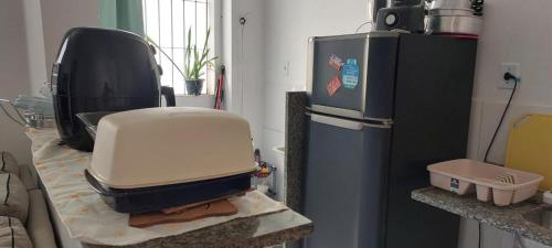 a large appliance sitting on a counter next to a refrigerator at Condomínio Citta COP30 in Marituba