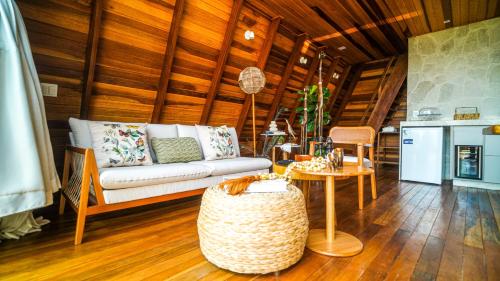a living room with a couch and a table at Zamaya Bangalôs in Sao Jorge
