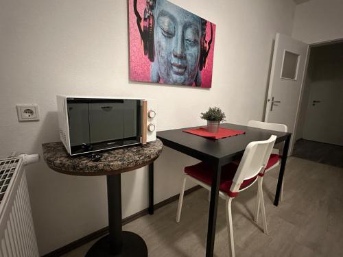 a room with a desk with a computer on a table at Fiddelhof in Bad Hersfeld
