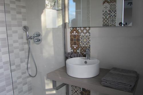 a white bathroom with a sink and a shower at Escale19 in Milly-la-Forêt