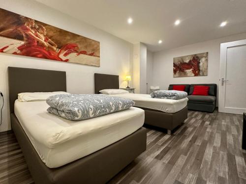 a room with two beds and a couch at Fiddelhof in Bad Hersfeld