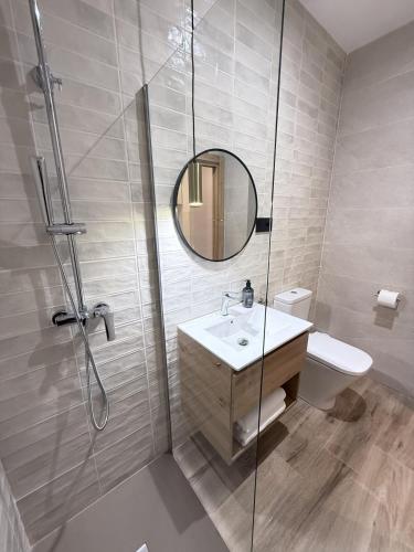 a bathroom with a shower and a sink and a mirror at Be RELAX TORREJON in Torrejón de Ardoz
