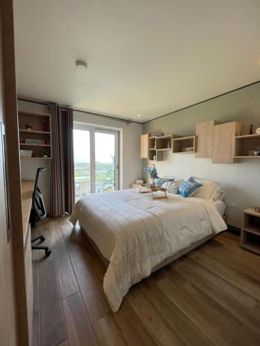 a bedroom with a large bed and a large window at Escapes in Simpson Bay