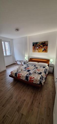 a bedroom with a bed and a wooden floor at San Paolo Hideout in Rome