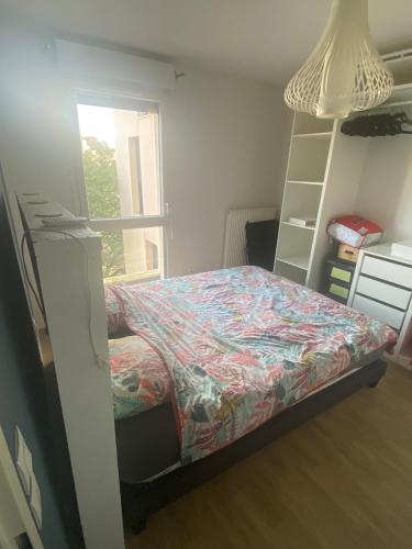 une chambre avec un lit et une bibliothèque dans l'établissement Appartement F2, à Gonfreville-l'Orcher