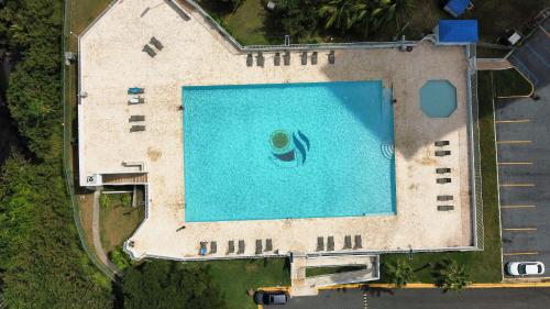 an overhead view of a large swimming pool at Marina Views & Island Adventures: Fajardo Condo with Pool in Beltran