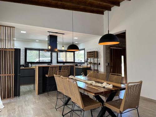 une salle à manger et une cuisine avec une table et des chaises dans l'établissement Casa Moderna, Barrio Nayades, à Pinamar