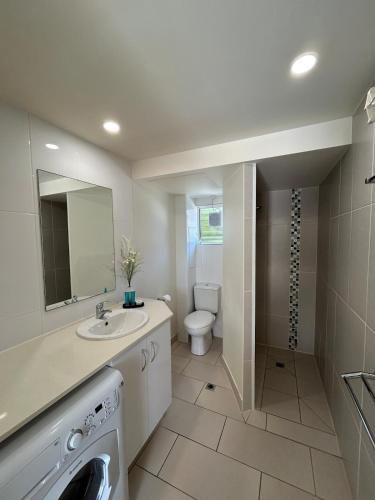 a white bathroom with a sink and a toilet at Luxury Coastal Escape at Endeavor Inn - Emu Park in Emu Park