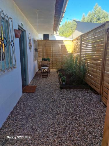 a courtyard with a fence and a table and chairs at Estudio Tana in Pedrógão Grande