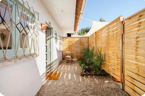 a courtyard of a house with a wooden fence at Estudio Tana in Pedrógão Grande