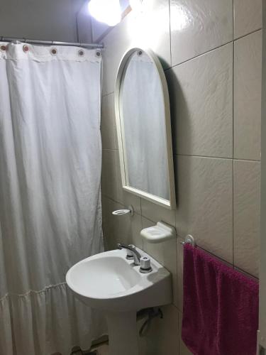 a bathroom with a sink and a mirror at La Cuadra - Puesto de Campo Argentino in Lobos