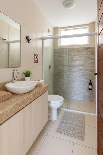 a bathroom with a sink and a toilet at Residence Cumbuco Paradise Beach in Cumbuco