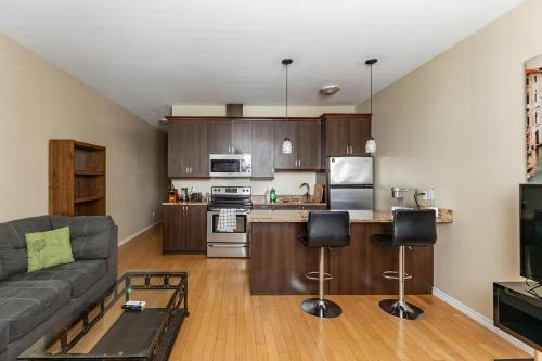 a living room with a couch and a kitchen at Suitestay Apartments Hotel in Ottawa