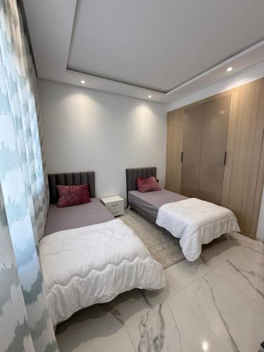 Ένα ή περισσότερα κρεβάτια σε δωμάτιο στο Appartement S2 haut standing meublé à Kantaoui