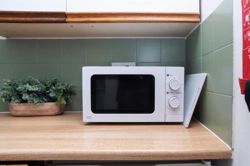 a microwave sitting on top of a table at Wellington Modern Studio - Free Parking in Wellington