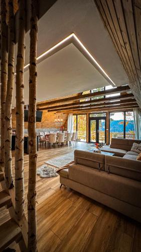 a living room with a couch and some trees at Black Roof in Arada