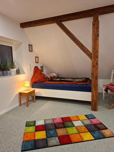 a room with a bed with a colorful rug at Hof Nordholz in Großenkneten