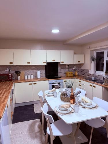 a kitchen with a white table and white cabinets at Grand Haven Dudley in Dudley