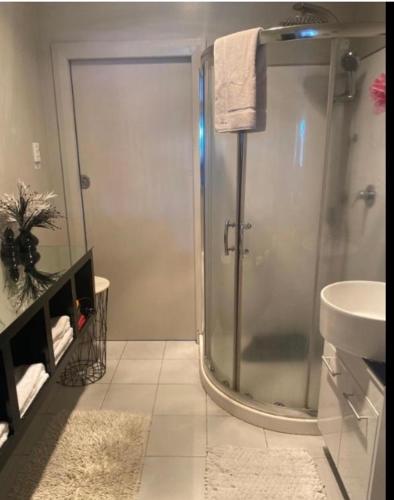 a bathroom with a shower and a sink at Skyline SkyRides Premium Property, see host info for pets in Rotorua