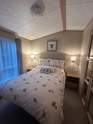 a bedroom with a large bed with animals on it at Glen-coo in Auchterarder