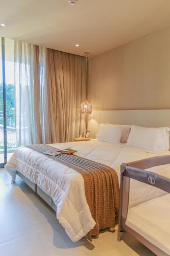 a hotel room with two beds and a window at Eagle Boutique Hotel in Guaramiranga
