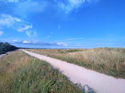 a dirt road in the middle of a field at 6 person holiday home in Væggerløse in Bøtø By