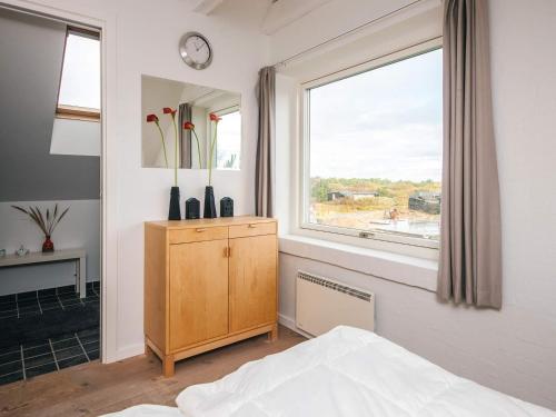 een slaapkamer met een bed, een raam en een dressoir bij Luxury Panoramic Cottage in Rindby-By Traum in Fanø
