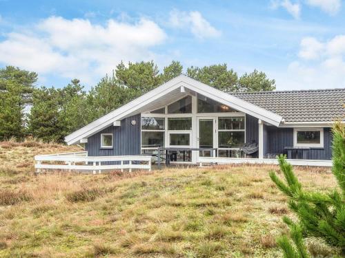 a house on a hill with a yard at 8 person holiday home in Fanø-By Traum in Fanø