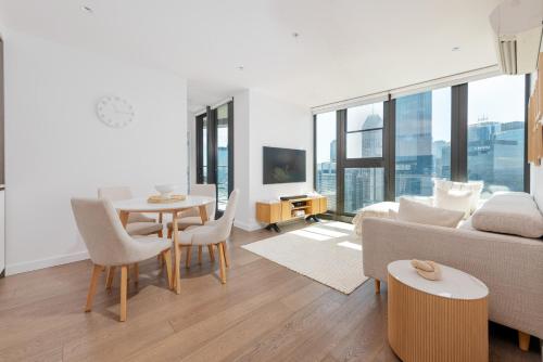 a living room with a couch and a table at Flinders St Central - Parking, Gym, Pool & Sauna in Melbourne