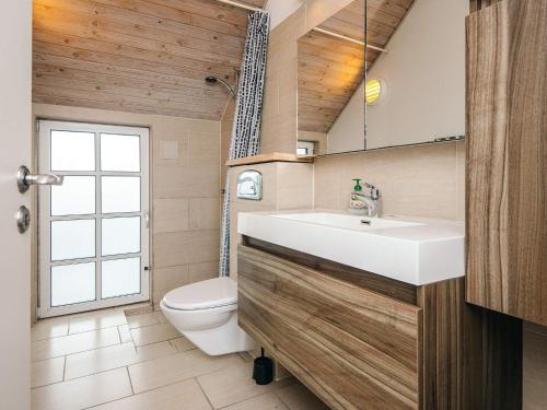 a bathroom with a sink and a toilet at Luxury Retreat with Pool - By Traum Ferienwohnungen in Fanø