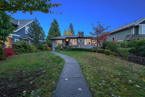 a house with a pathway in front of a yard at Renovated North Vancouver Gem in North Vancouver