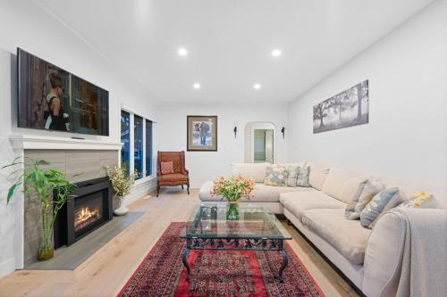 a living room with a couch and a fireplace at Renovated North Vancouver Gem in North Vancouver