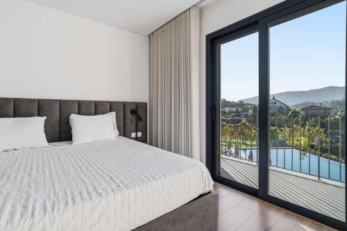 Un dormitorio con una cama y una ventana grande en Ermal Terrace, en Vieira do Minho