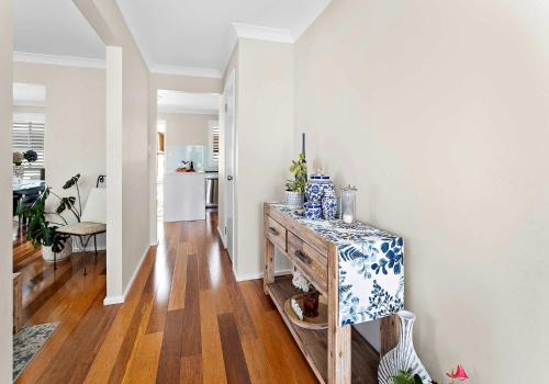 a living room with a table with a blue and white pattern at Haus on Moore in Oak Flats