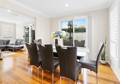 a dining room with a table and chairs at Haus on Moore in Oak Flats