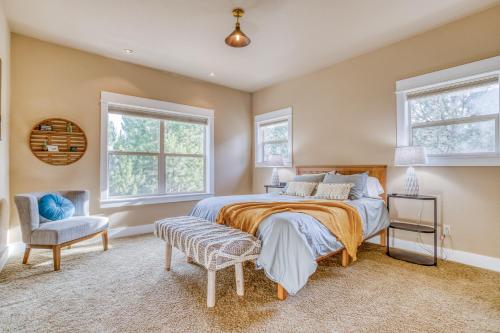 a bedroom with a bed and a chair and two windows at Beautiful Bend Retreat - Meredith Lodging in Bend