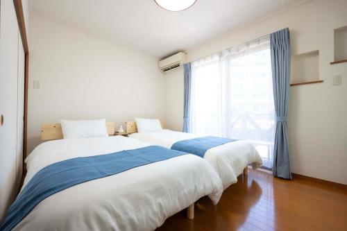 Ένα ή περισσότερα κρεβάτια σε δωμάτιο στο Shiokaze