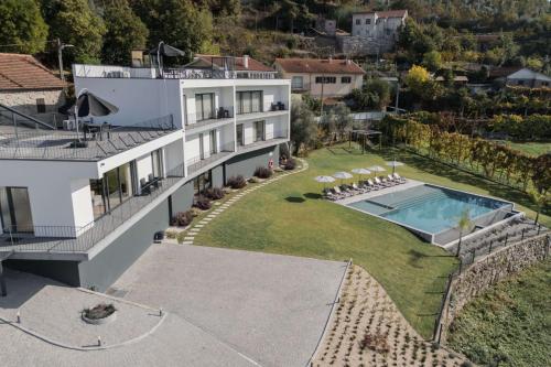 an aerial view of a house with a swimming pool at Ermal Terrace in Vieira do Minho