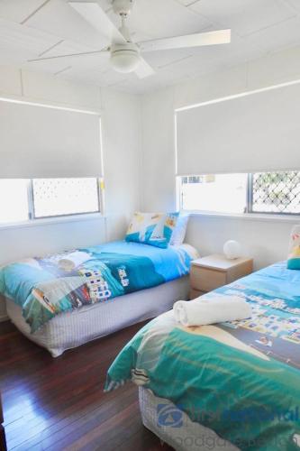 a bedroom with two beds and a ceiling at 58 The Esplanade in Woodgate