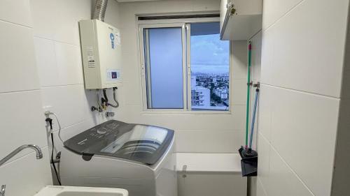 a small bathroom with a sink and a window at Condomínio próximo a ponte Hercílio Luz in Florianópolis