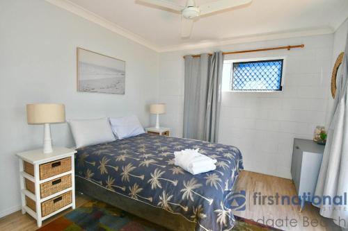 a bedroom with a bed and a window at 50 The Esplanade in Woodgate