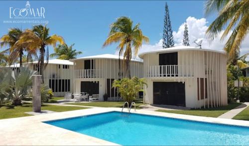 a house with a swimming pool in front of it at EcoMar Rentals: Villa in Cabo Rojo